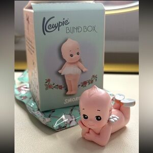Kewpie blind box figurine laying down